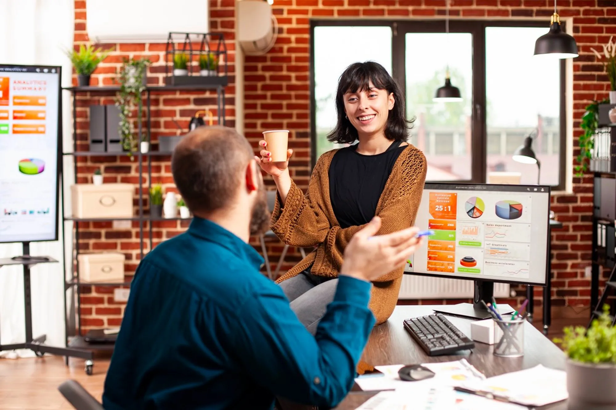 Two colleagues talking through a website change