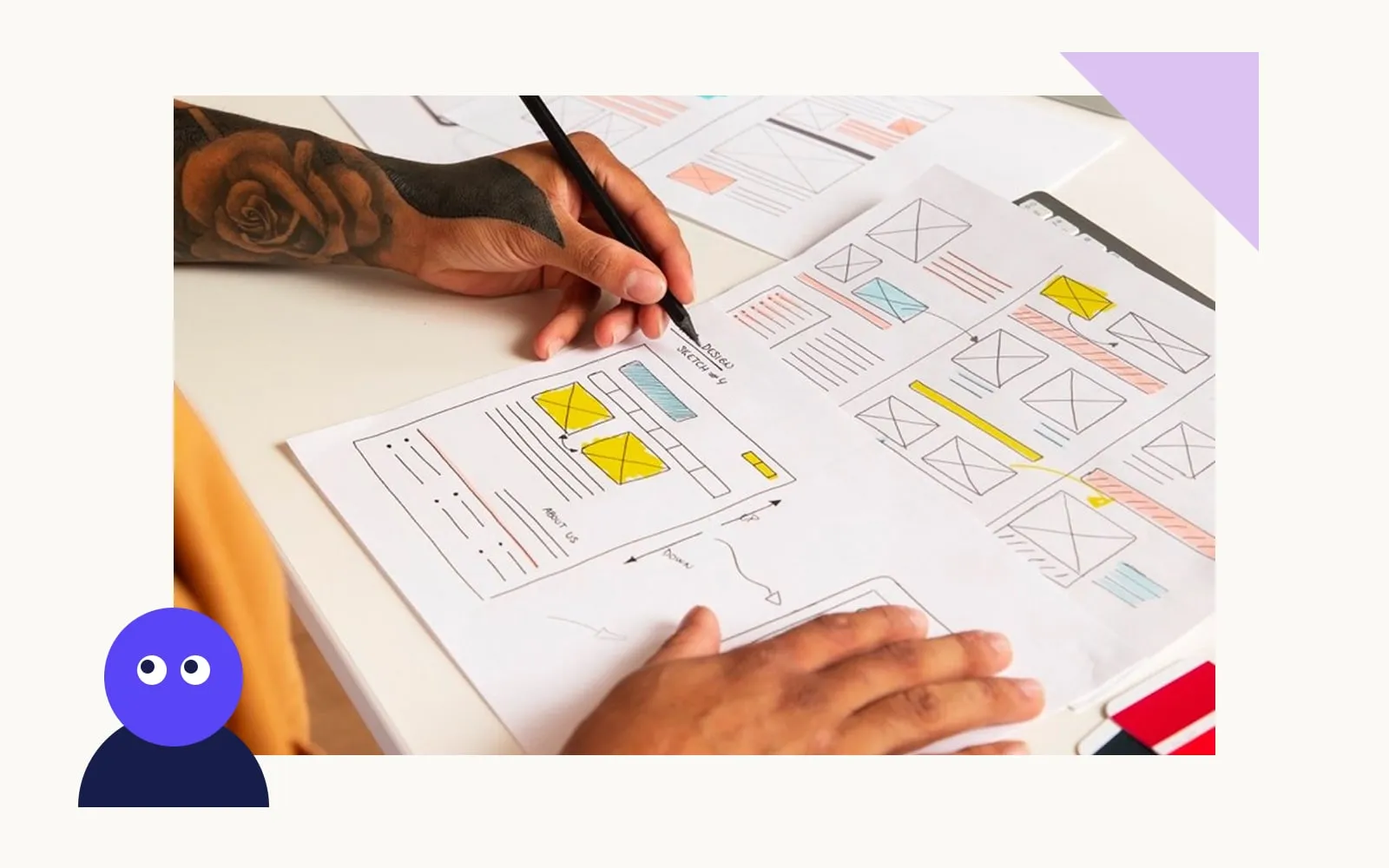 A designer sketching website wireframes on paper at a desk