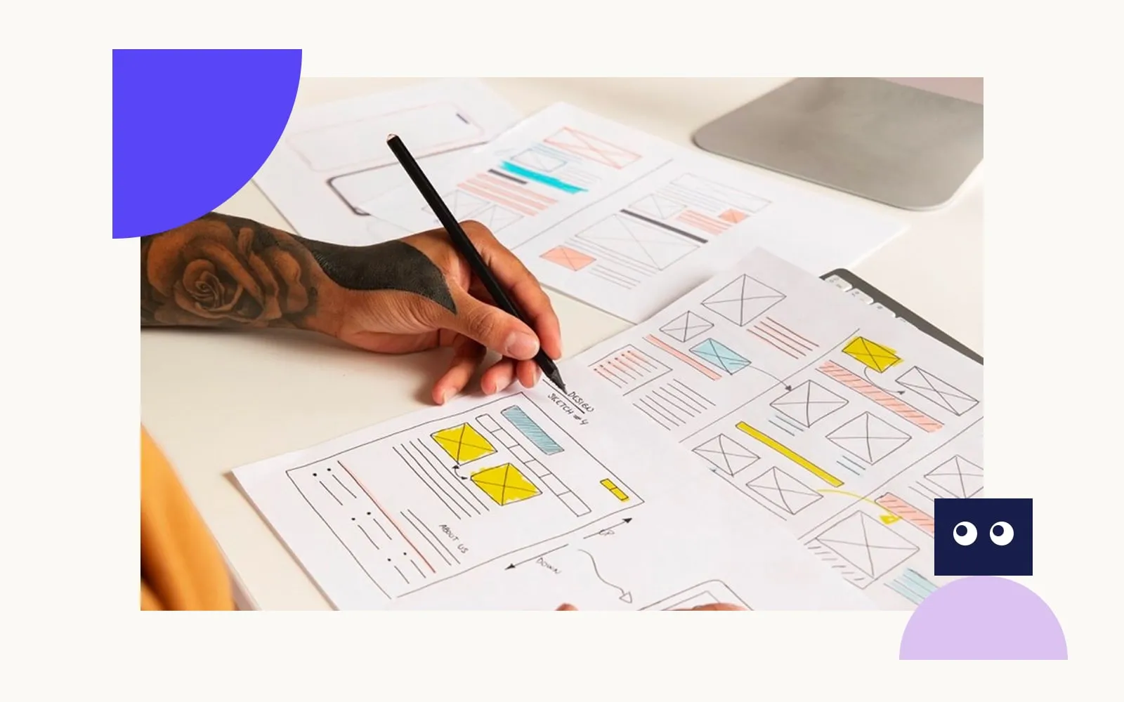 Hands sketching website wireframes on paper