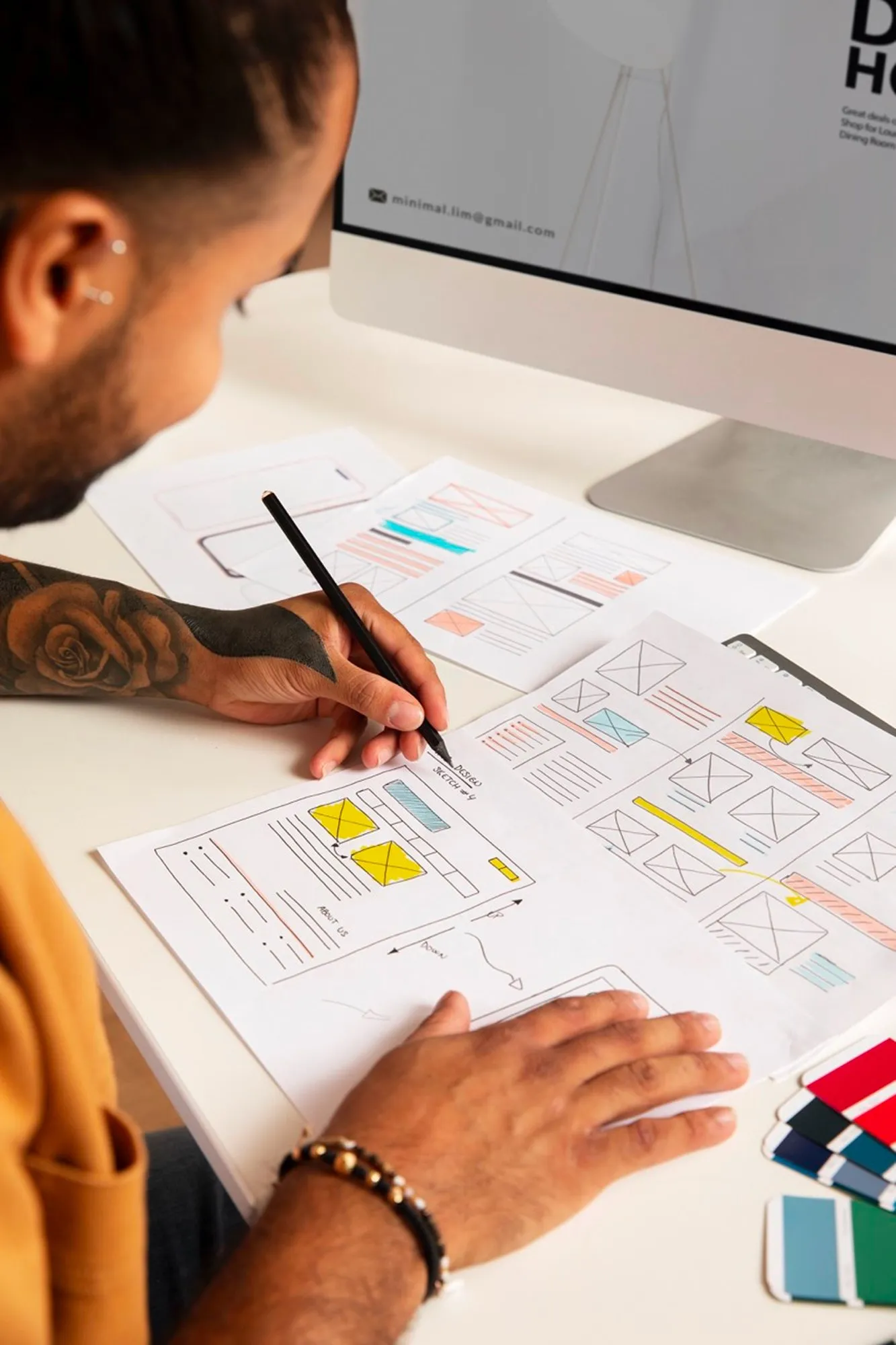 A designer sketching an interface on paper